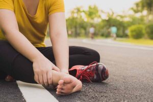 lady sitting down after suffering sprained ankle